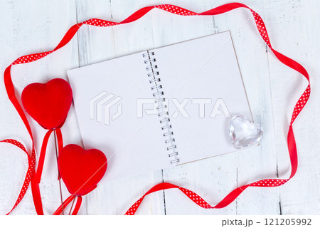 Valentines day toy hearts and notepad for your text. Top view on wooden table Valentines day toy hearts and notepad for your text. Top view on wooden table 121205992