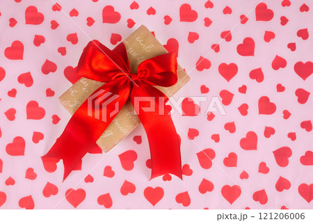 Valentine's Day. Presented as a red ribbon on a pink paper with red hearts 121206006