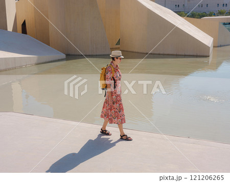 Young woman exploring Qasr Al Hosn Park in Abu Dhabi. Surrounded by lush greenery and historical landmarks, she enjoys the serene atmosphere and Emirati heritage in heart of city. Young woman exploring Qasr Al Hosn Park in Abu Dhabi. Surrounded by lush greenery and historical landmarks, she enjoys the serene atmosphere and Emirati heritage in heart of city. 121206265