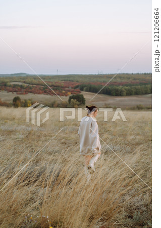 Young woman enjoys autumn day. People, lifestyle, travel, nature and vacations concept. 121206664