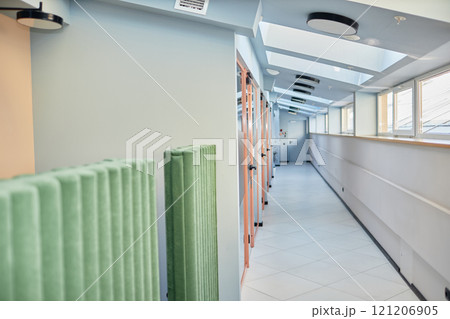 Background shot of hallway with roof windows and transparent doors leading to individual office rooms in modern business center, copy space Background shot of hallway with roof windows and transparent doors leading to individual office rooms in modern business center, copy space 121206905
