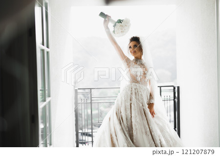 Bride holding big and beautiful wedding bouquet with flowers 121207879