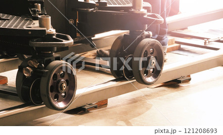 Camera trolley or camera dolly cart rails for filmmaking on studio shooting set. Pro videographer dolly rail track for filming movie mounted on studio floor. Video production dolly and crews in set. Camera trolley or camera dolly cart rails for filmmaking on studio shooting set. Pro videographer dolly rail track for filming movie mounted on studio floor. Video production dolly and crews in set. 121208693