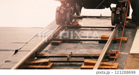 Camera trolley or camera dolly cart rails for filmmaking on studio shooting set. Pro videographer dolly rail track for filming movie mounted on studio floor. Video production dolly and crews in set. Camera trolley or camera dolly cart rails for filmmaking on studio shooting set. Pro videographer dolly rail track for filming movie mounted on studio floor. Video production dolly and crews in set. 121208699
