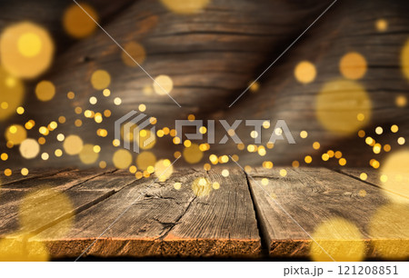 festive holiday background with gold bokeh lights. blurred wooden background with Christmas lights, copy space 121208851