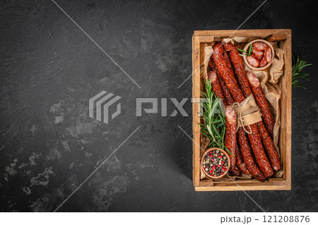 kabanosy thin dry sausages on a wooden board, top view. copy space 121208876
