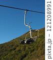 Cable car in the mountains on a background of blue sky. Cable car in the mountains on a background of blue sky. 121208991