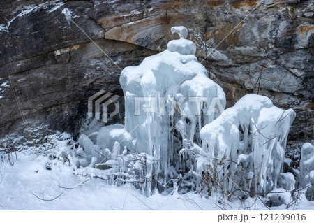 Natural icicles on a stone wall, Norway 121209016