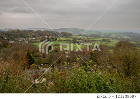 View of the English countryside near Shaftesbury, Dorset with fields, trees, hills and a farm with sheep. View of the English countryside near Shaftesbury, Dorset with fields, trees, hills and a farm with sheep. 121209697