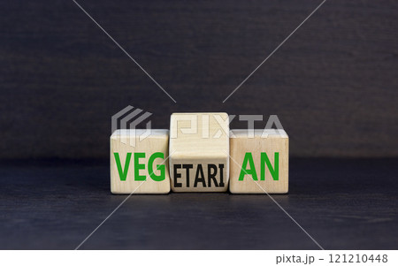 Vegetarian or vegan symbol. Concept words Vegetarian Vegan on wooden block. Beautiful black table black background. Healthy lifestyle vegetarian or vegan concept. Copy space. 121210448