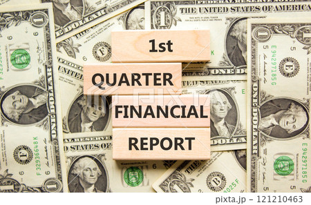 1st quarter financial report symbol. Concept words 1st quarter financial report on beautiful wooden blocks. Beautiful dollar background. Business 1st quarter financial report concept. Copy space. 121210463