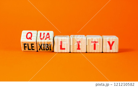 Quality or flexibility symbol. Concept words Quality Flexibility on wooden cubes. Beautiful orange table orange background. Business and quality or flexibility concept. Copy space. 121210582