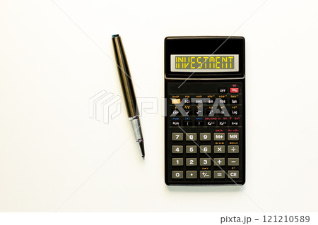 Investment symbol. Concept word Investment on beautiful black calculator. Beautiful white paper background. Beautiful black pen. Business investment concept. Copy space. 121210589