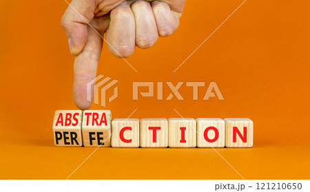 Perfection or abstraction symbol. Concept words Perfection Abstraction on beautiful wooden blocks. Beautiful orange background. Businessman hand. Business perfection or abstraction concept. Copy space 121210650