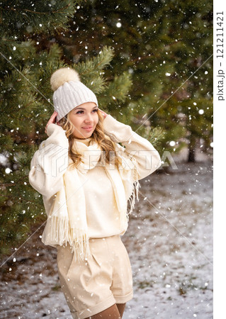 Pretty stylish young woman in forest. Snowy weather. 121211421