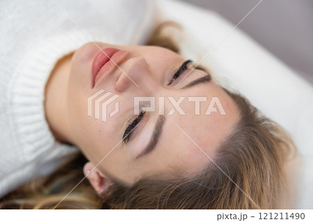 Close up face of beautiful woman lying on spa bed before procedure in cosmetology clinic Close up face of beautiful woman lying on spa bed before procedure in cosmetology clinic 121211490