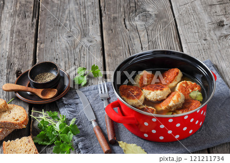 turkey potato cakes in a red pot, top view 121211734