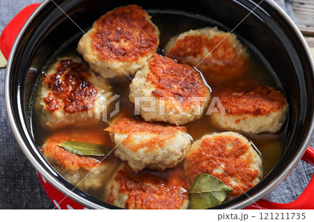 turkey potato cakes in a red pot, top view 121211735