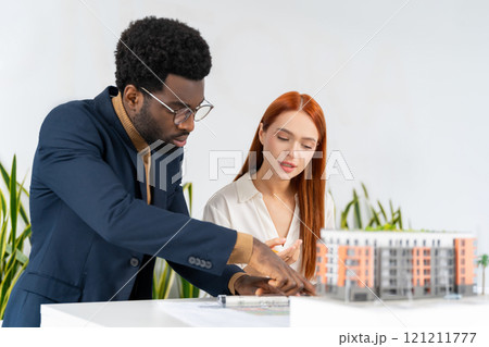 Colleagues in the office working together and looking involved 121211777