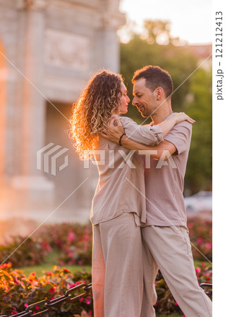 Couple dancing swing in front of puerta de alcala in madrid at sunset Couple dancing swing in front of puerta de alcala in madrid at sunset 121212413