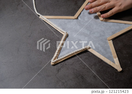 Christmas star made of ice cream sticks. Gift idea. Do it yourself instruction eco-friendly decoration. Zero waste Making handmade presents children's diy projects. Holiday family time 121215423