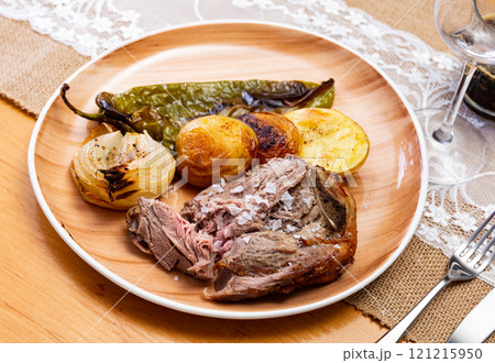 Fried lamb served with potatoes and peppers 121215950