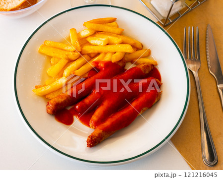 Sausages with potato slices in tomato sauce Sausages with potato slices in tomato sauce 121216045