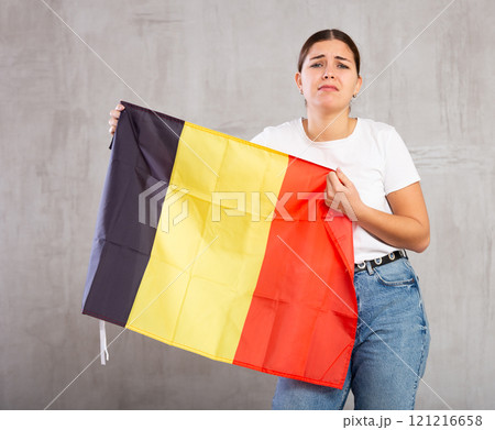 Unhappy female Germany team fan holding national flag 121216658