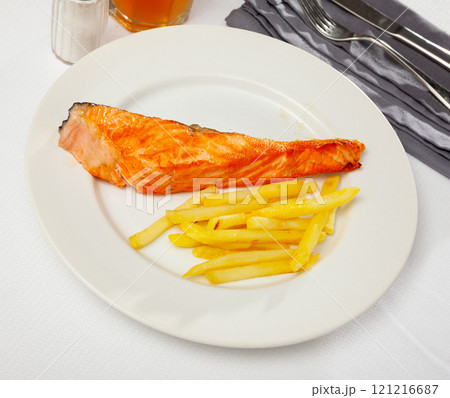 Roasted steak of salmon with French fried potatoes Roasted steak of salmon with French fried potatoes 121216687