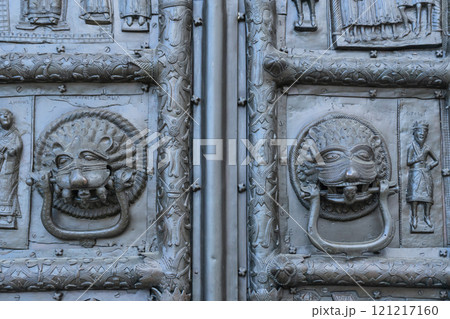 Fragment of Sigtuna gates. Bronze doors in St. Sophia Cathedral in Novgorod. Door handles are shaped like animal masks with two headed snakes attached to them. Heads of sinners are in their mouths. Fragment of Sigtuna gates. Bronze doors in St. Sophia Cathedral in Novgorod. Door handles are shaped like animal masks with two headed snakes attached to them. Heads of sinners are in their mouths. 121217160