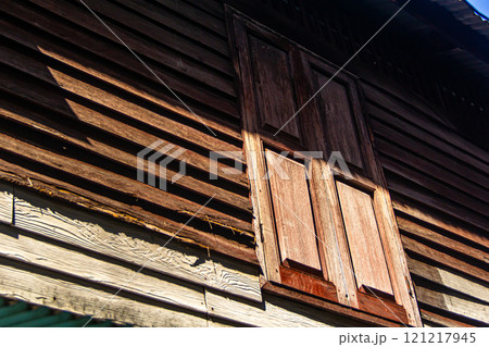 Wooden window of an old house 121217945