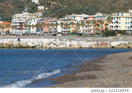 Breakwater on Mediterranean beach. Nature of sea and historical buildings. Sestri Levante, Liguria. Italian architecture. Breakwater on Mediterranean beach. Nature of sea and historical buildings. Sestri Levante, Liguria. Italian architecture. 121218874