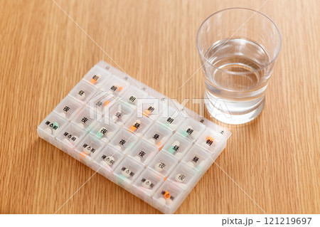 ピルケースに入った常用薬とグラスに入った水 ピルケースに入った常用薬とグラスに入った水 121219697