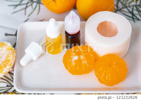 Handmade soap in the form of a tangerine with bottles of dye, flavor, a block of glycerin soap base, silicone mold, pipette. Soap as a gift, home-made 121222626