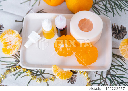 Handmade soap in the form of a tangerine with bottles of dye, flavor, a block of glycerin soap base, silicone mold, pipette. Soap as a gift, home-made 121222627