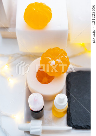 Handmade soap in the form of a tangerine with bottles of dye, flavor, a block of glycerin soap base, silicone mold, pipette. Soap as a gift, home-made Handmade soap in the form of a tangerine with bottles of dye, flavor, a block of glycerin soap base, silicone mold, pipette. Soap as a gift, home-made 121222656