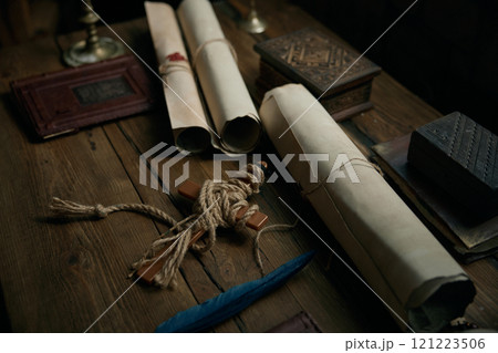 Obsolete medieval wooden table with traditional antique documents and cross 121223506