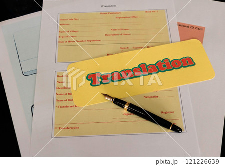 translation paperwork on table in office translation paperwork on table in office 121226639