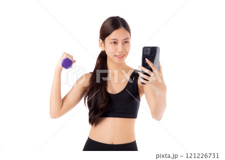 Portrait young asian woman lifting dumbbell and watching smartphone isolated. 121226731