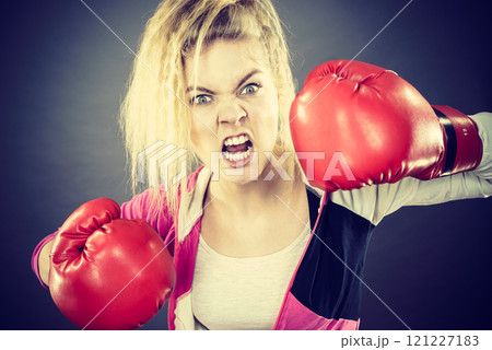 Angry woman wearing boxing gloves 121227183