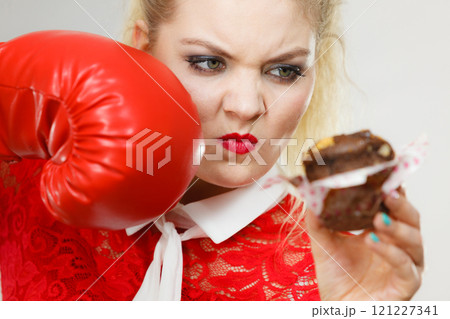 Woman boxing chocolate cupcake Woman boxing chocolate cupcake 121227341