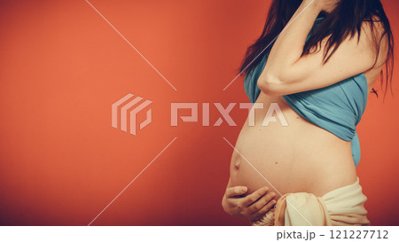 Closeup on tummy of pregnant woman. 121227712