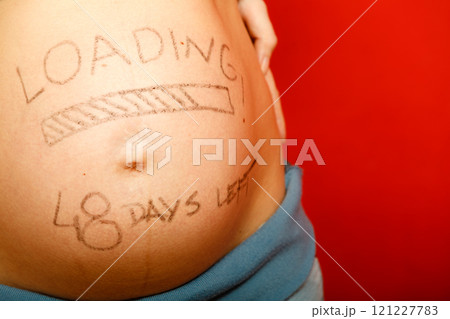 Pregnant woman with loading concept painted on her belly 121227783
