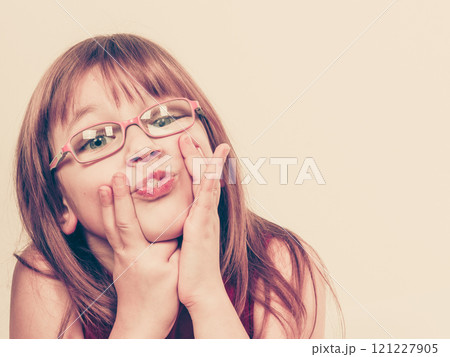 Funny little girl in glasses 121227905