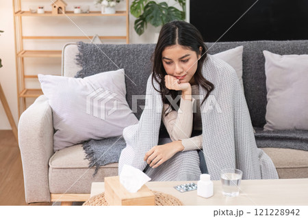Sick and unwell a woman's struggle at home living room emotional scene cozy environment intimate viewpoint Sick and unwell a woman's struggle at home living room emotional scene cozy environment intimate viewpoint 121228942