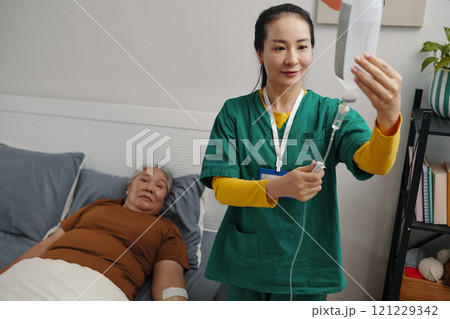 Nurse Caring About Old Woman At Home Nurse Caring About Old Woman At Home 121229342