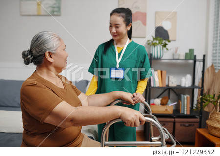 Senior Woman Trying To Walk With Walker 121229352