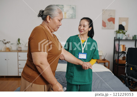 Senior Woman Having Caregiver At Home 121229353