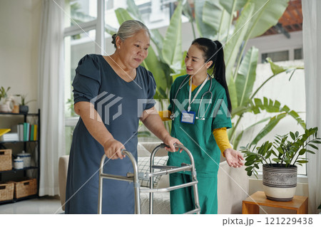 Young Caregiver Caring About Senior Woman Young Caregiver Caring About Senior Woman 121229438