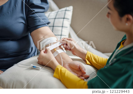 Nurse Making IV Drip To Patient Nurse Making IV Drip To Patient 121229443